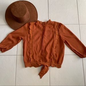 Almost new orange high neck blouse.